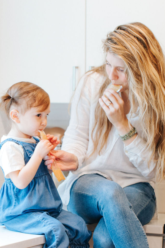 Mom and daughter trying EllyPop freezer pops in kitchen in Portland Oregon