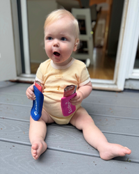 Baby boy enjoying EllyPop freezer pops on a summer day