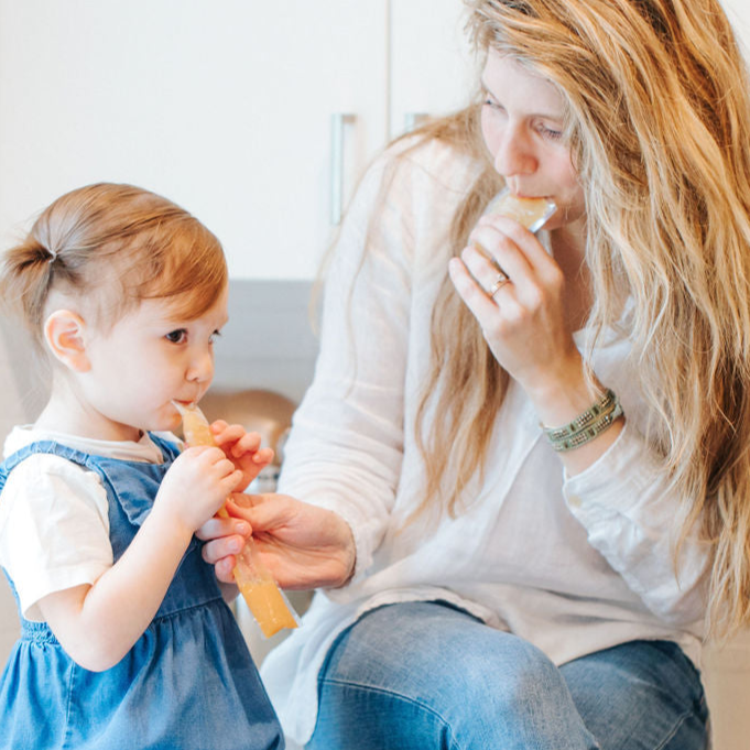 Mom and daughter trying EllyPop freezer pops in kitchen in Portland Oregon 